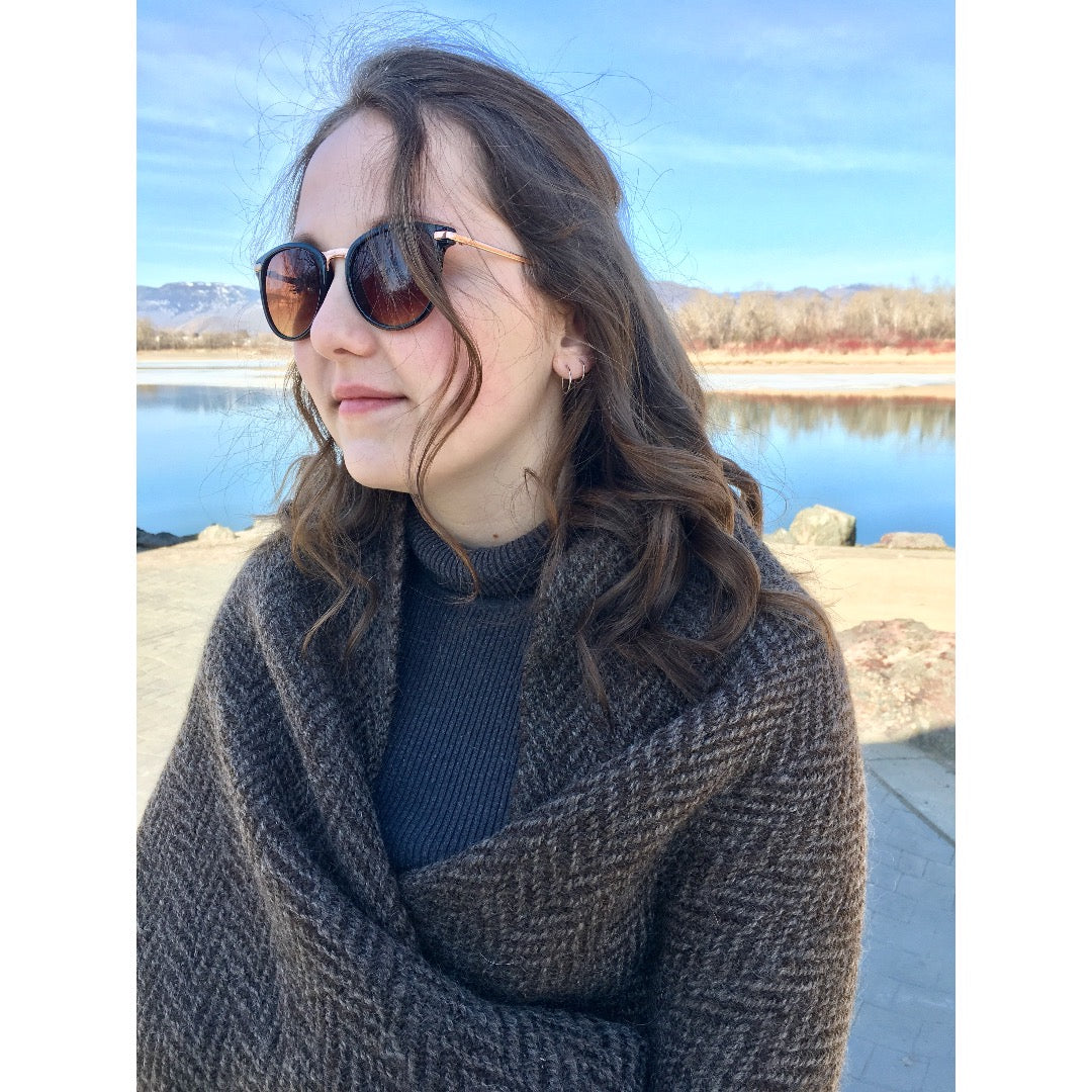 Model wearing Herringbone Scarf around shoulders like a shawl