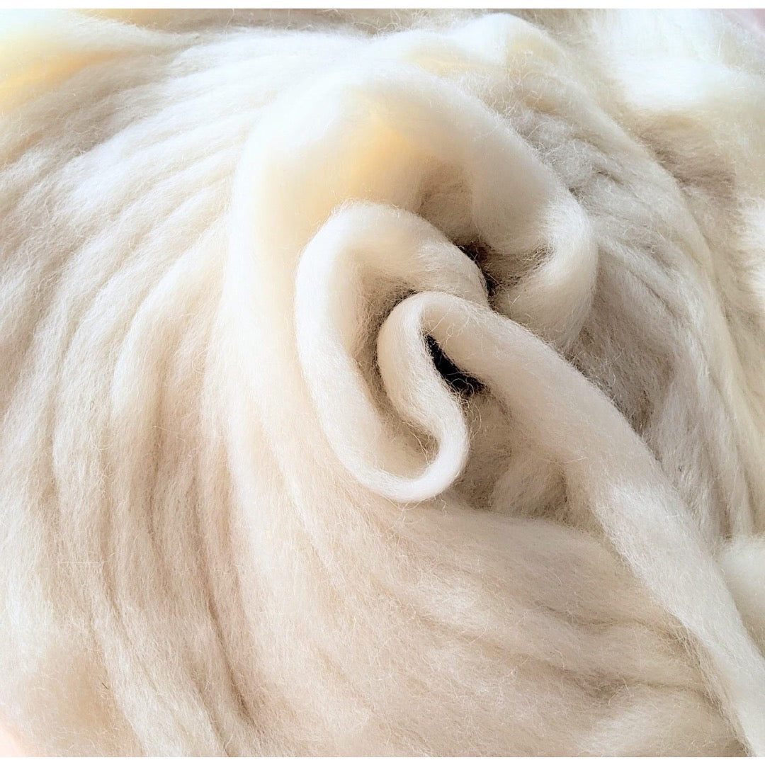 Top-down view of a circular pile of snow white coloured combed top