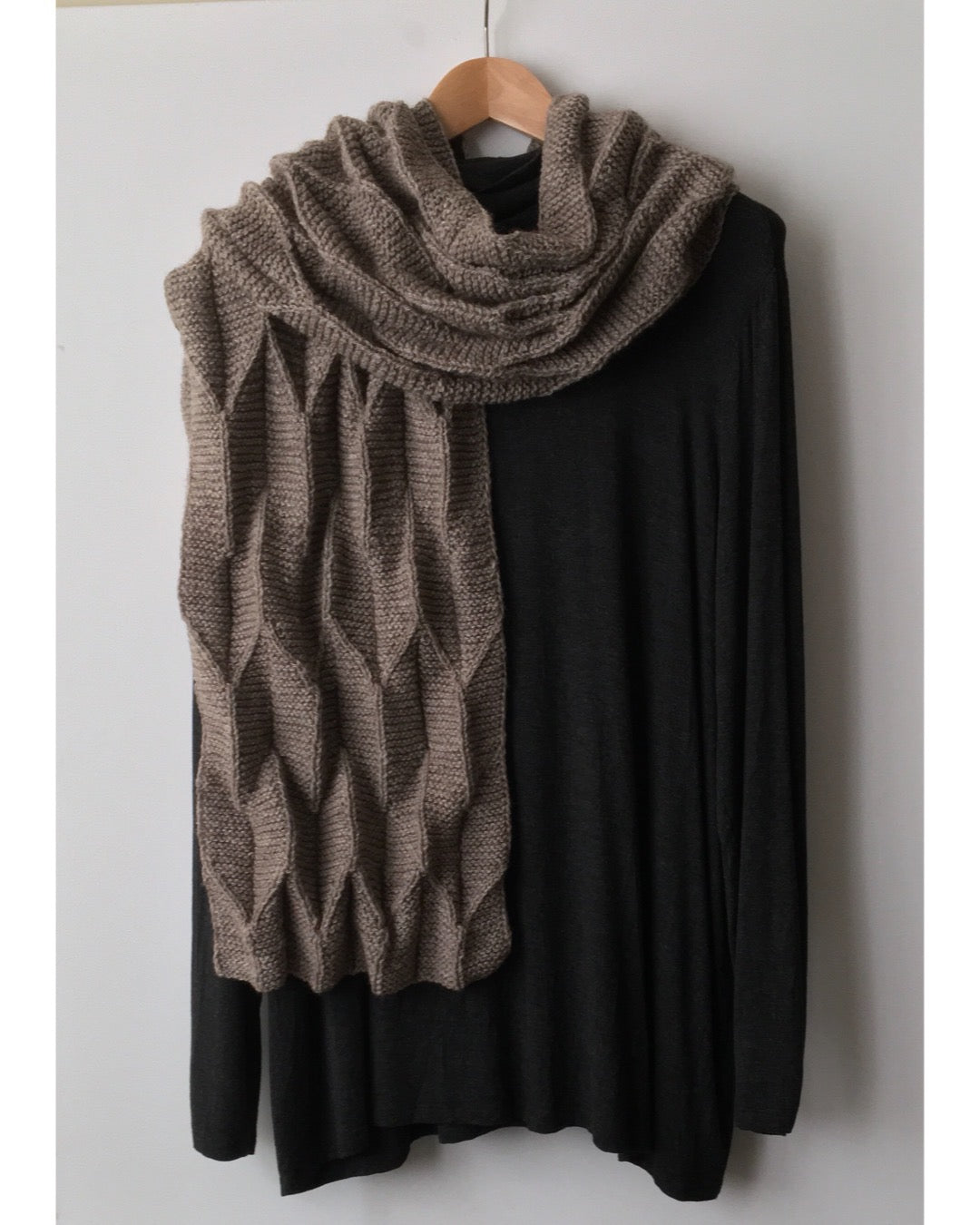 A textured scarf knit in Copaca DK draped over a black top