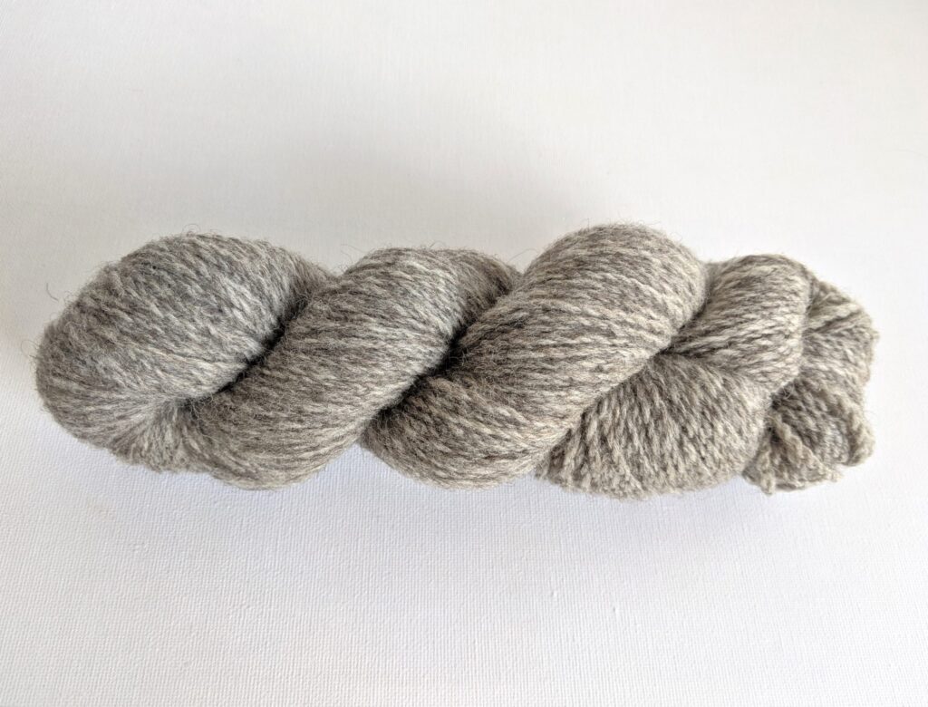 One hank of cool grey CVMco worsted weight yarn