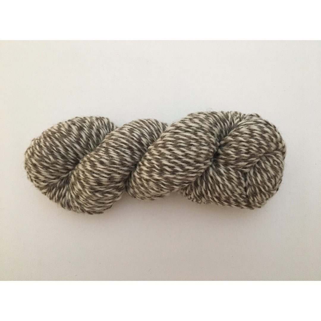 One hank of marled dark grey and white CVMco worsted weight yarn