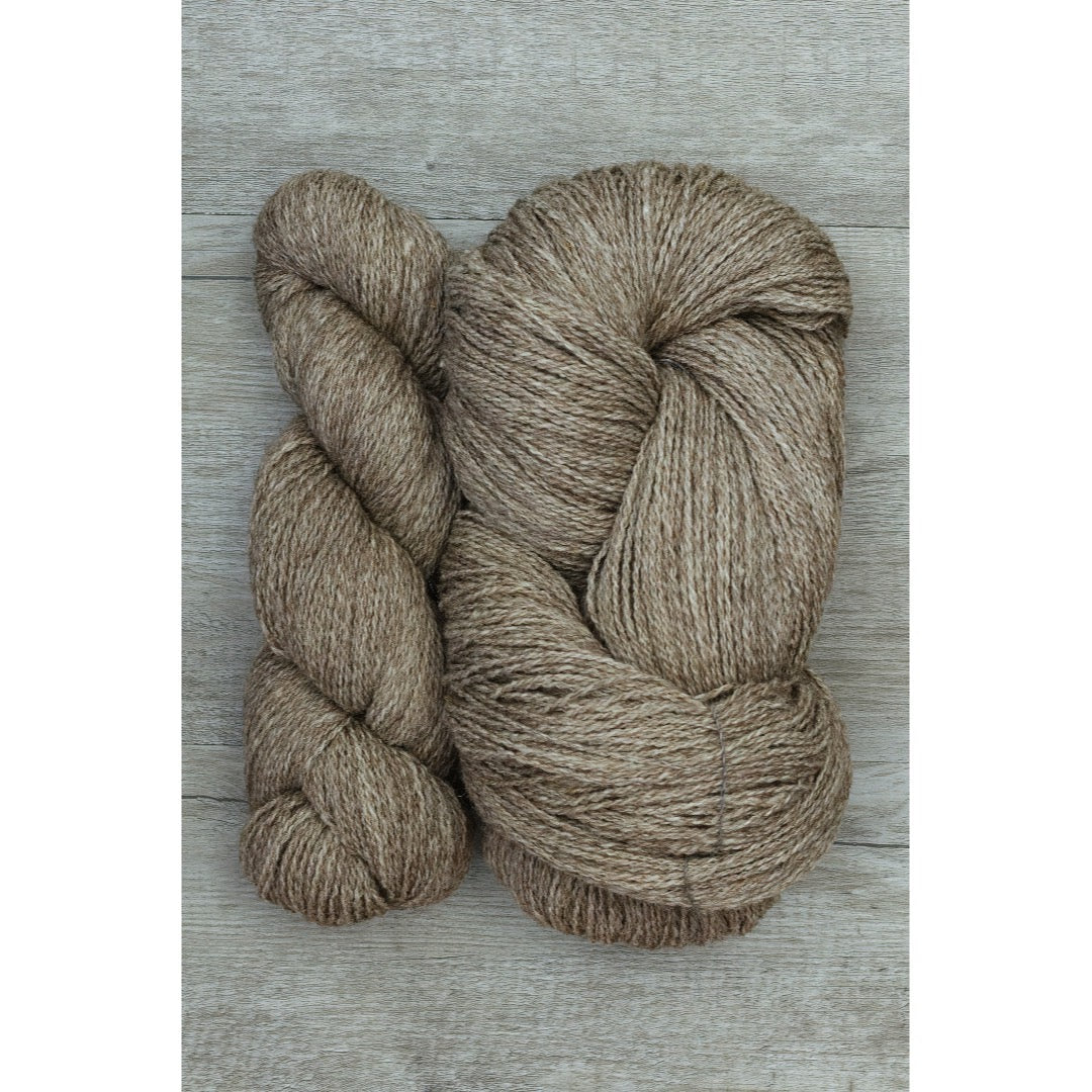 One full and one half hank of ginger brown Copaca Fingering yarn