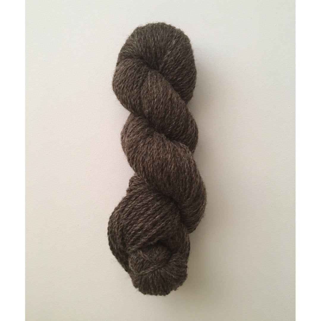 One hank of undyed heather brown worsted weight wool yarn