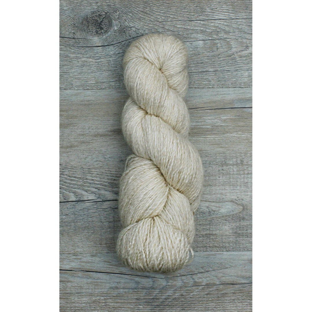 One beige coloured hank of Moco Fingering yarn