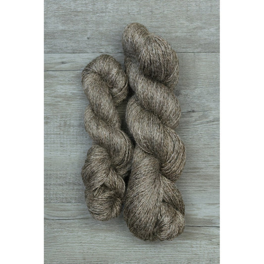 One half and one full hank of shiny dark grey mohair fingering yarn