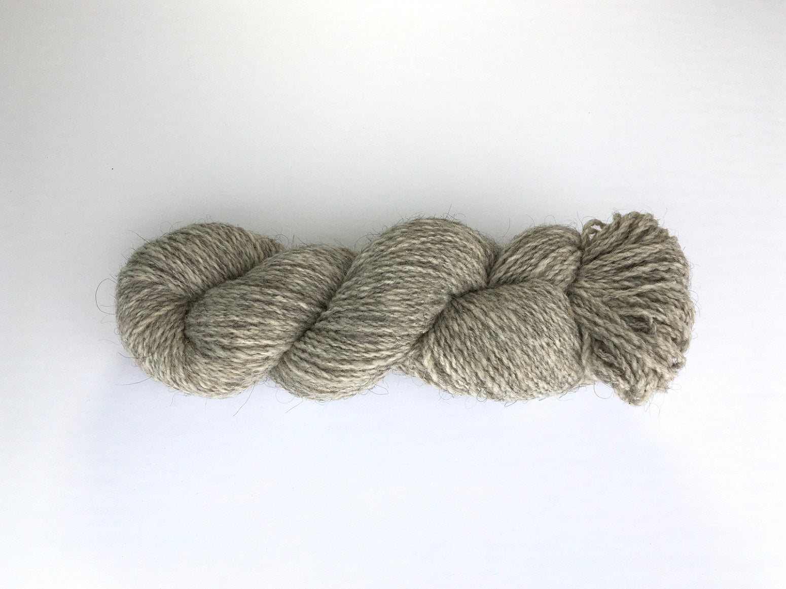 One hank of heathered light cool grey Ramo Worsted weight yarn
