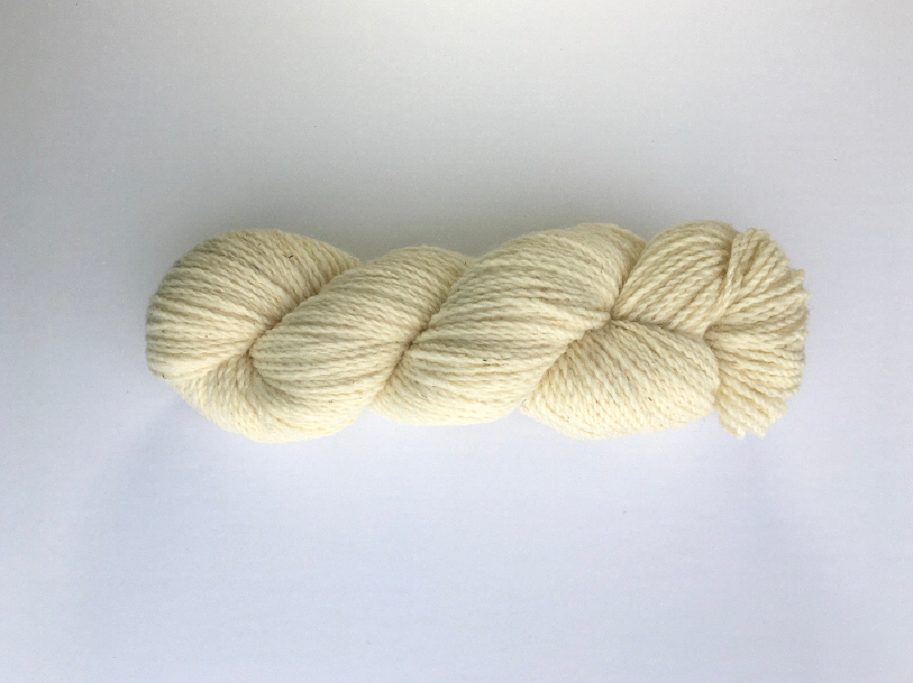 One hank of creamy white Ramo Worsted weight yarn
