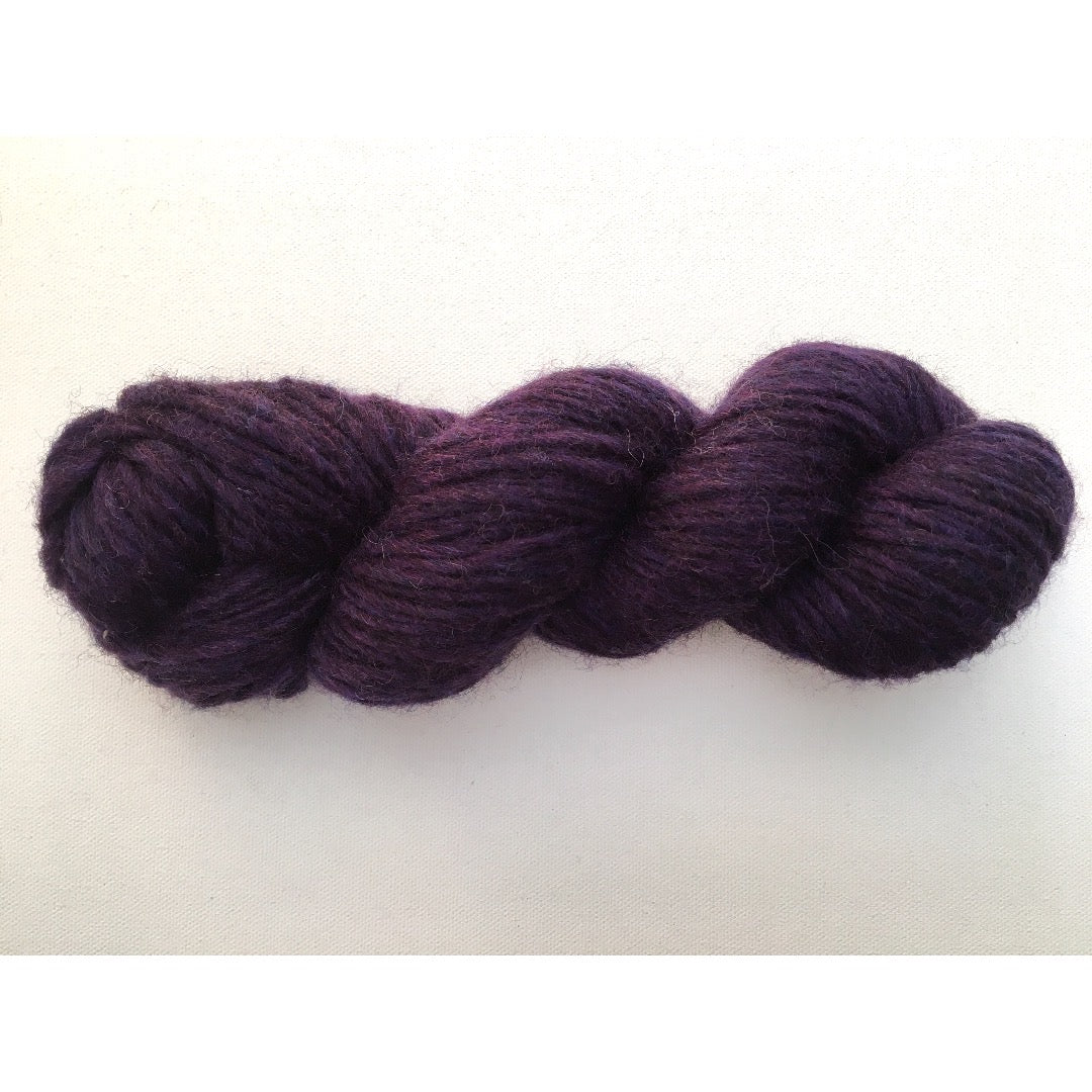 One bright dark purple hank of Romney Bulky yarn