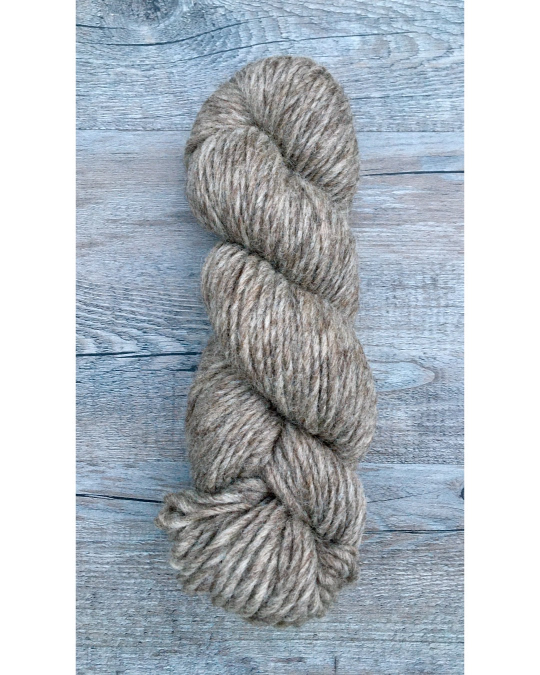 One hank of medium grey Romney Bulky yarn.