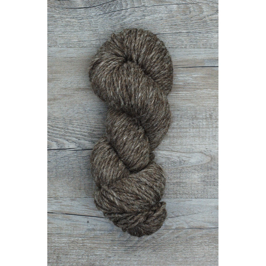 One hank of heathered dark brown bulky Roram yarn