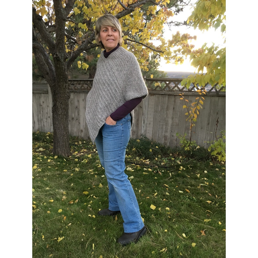 Model wearing poncho angled left