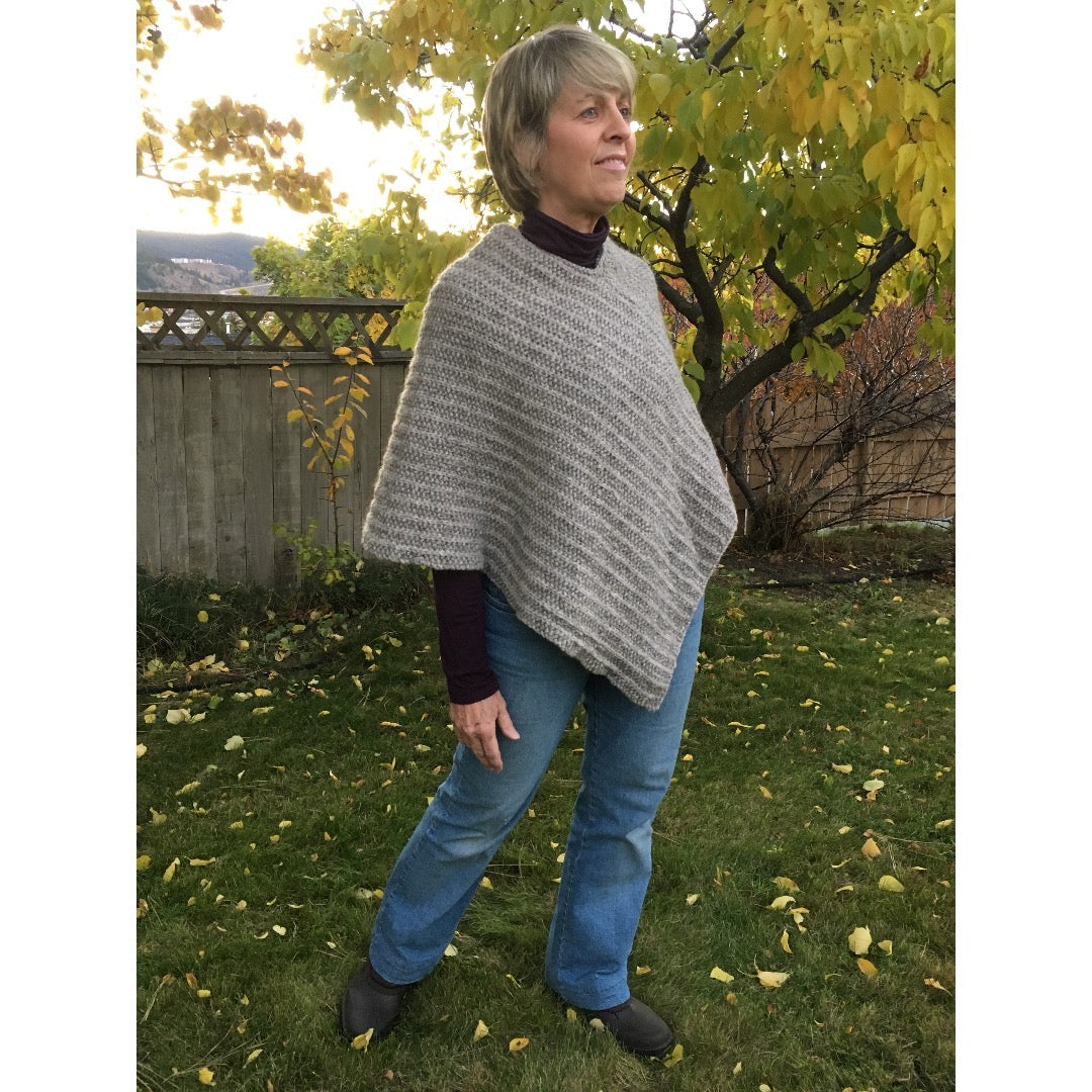 Model wearing poncho angled right